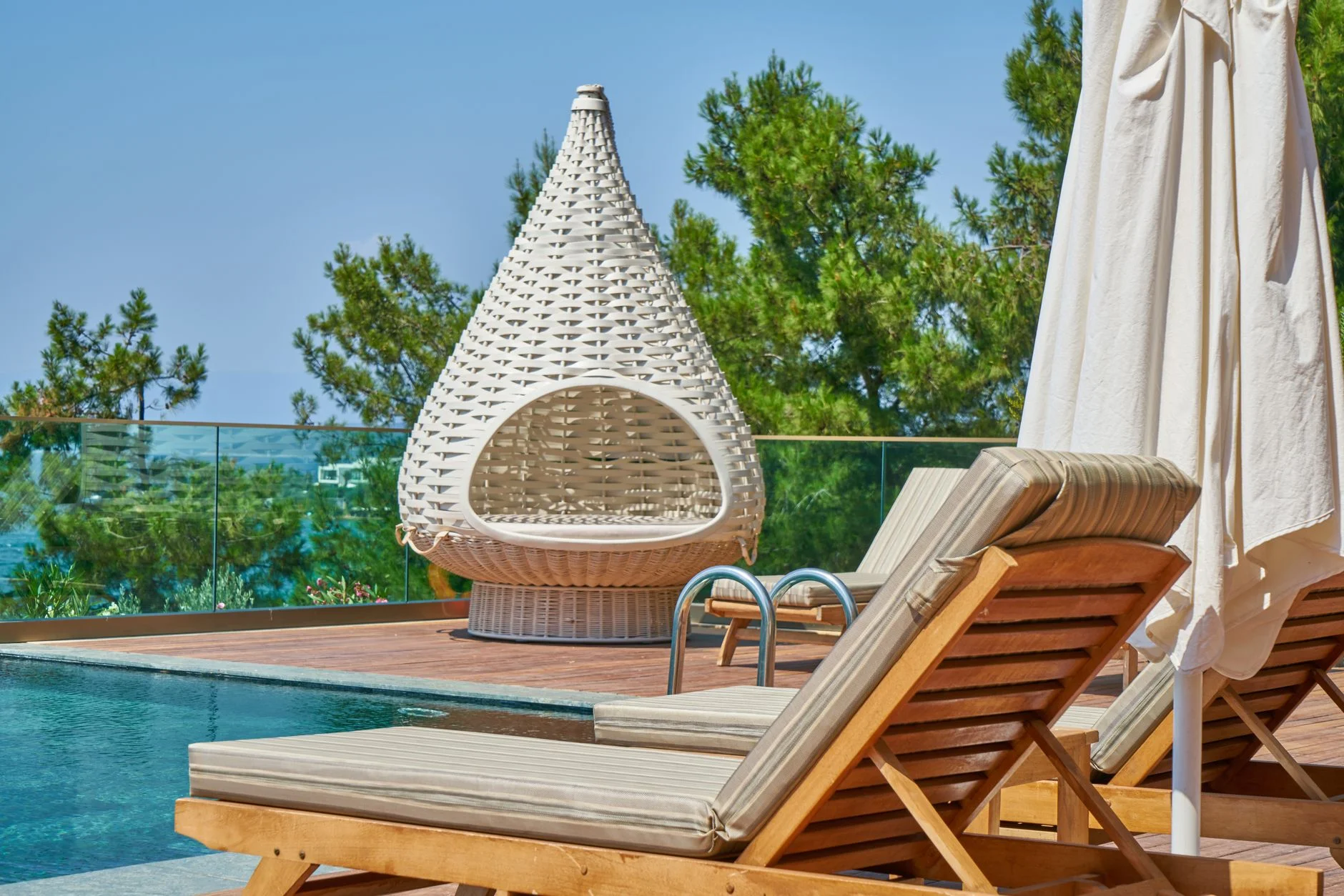 intricately woven rattan chair with tropical plants in the background